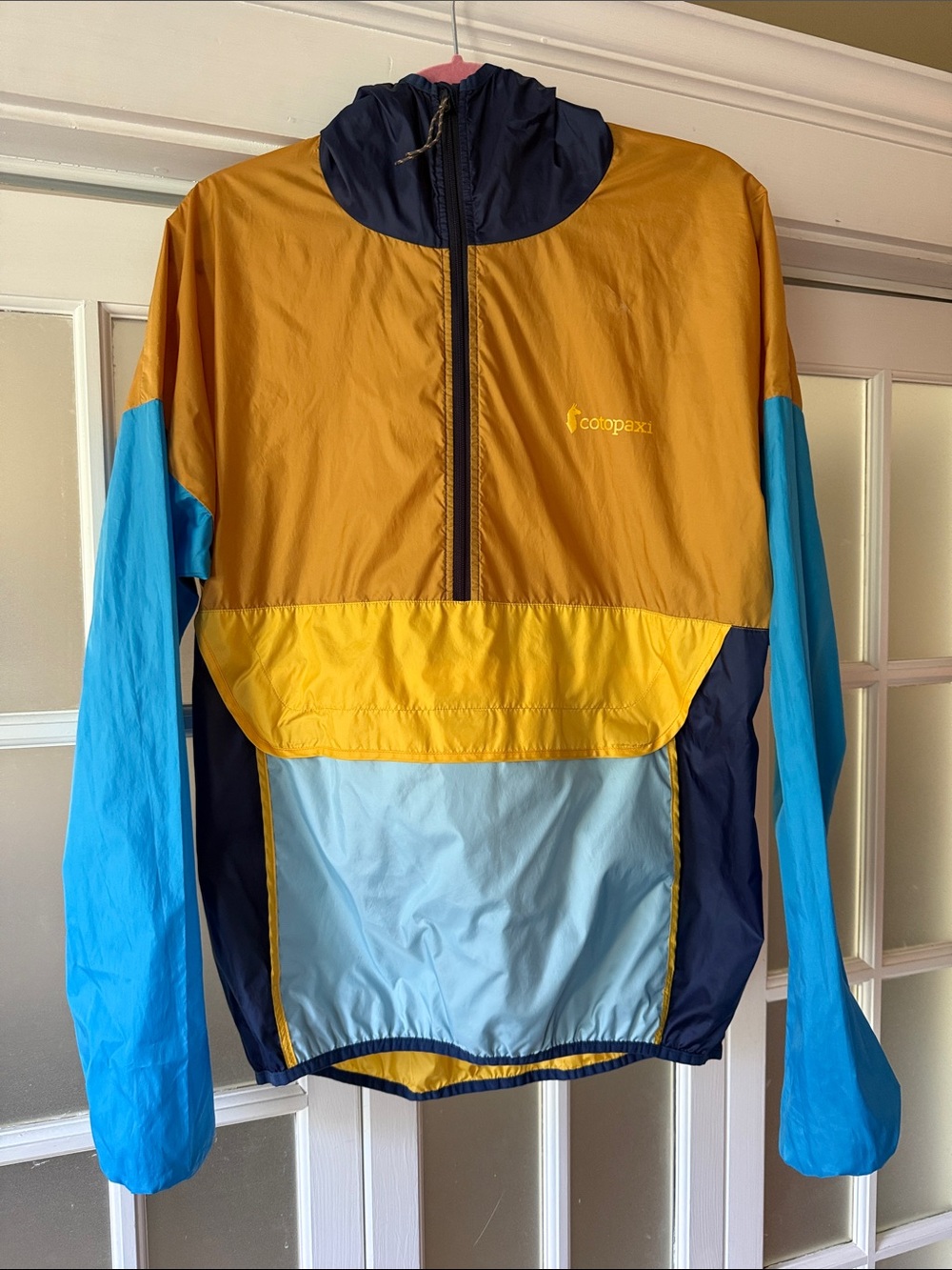 Cotopaxi Teca Windbreaker in Mustard, Light Blue & Navy